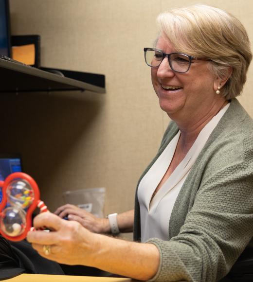 Dr. Oakes working with a baby toy in her lab